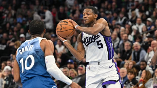 Nov 24, 2023; Minneapolis, Minnesota, USA; Sacramento Kings guard De'Aaron Fox (5) controls the ball as Minnesota Timberwolves guard Mike Conley (10) defends during the game at Target Center. Mandatory Credit: Jeffrey Becker-USA TODAY Sports